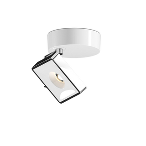 Studio von GRAU, weiße Designerleuchte mit verstellbarem Leuchtenkopf und glänzender Oberfläche für modernes Lichtdesign.