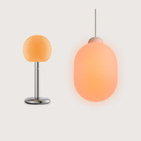 Fire Table & Sun Bundle von GRAU mit mundgeblasenem Glas, Aluminiumfuß und dimmbarer, warmweißer LED-Leuchte im modernen Design.